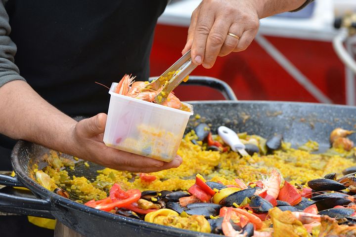 Man servicing paella catering in Sydney
